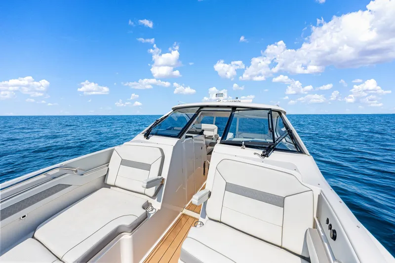 Slide: The Image of 2022 Pursuit DC 365 Dual Console boat on open sea under blue sky. - 69