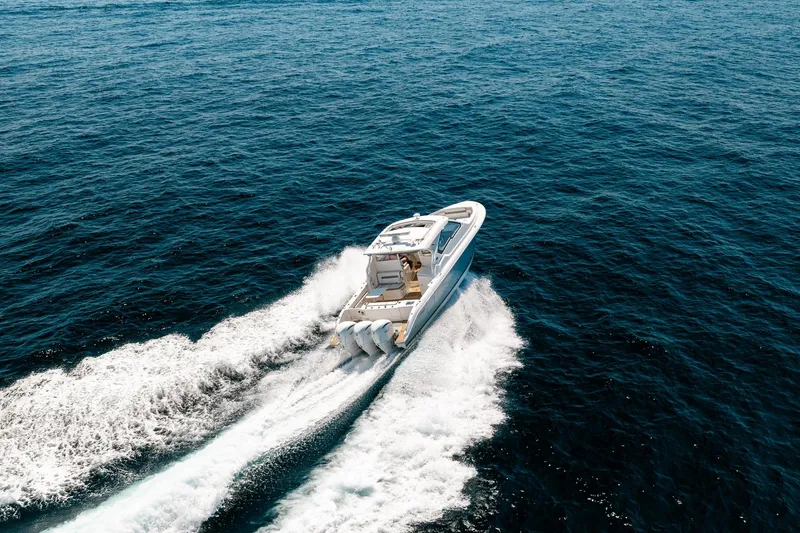 Slide: The Image of 2022 Pursuit DC 365 Dual Console cruising on open ocean waters. - 70