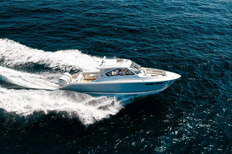 Slide: The Image of 2022 Pursuit DC 365 Dual Console boat cruising on open water. - 71