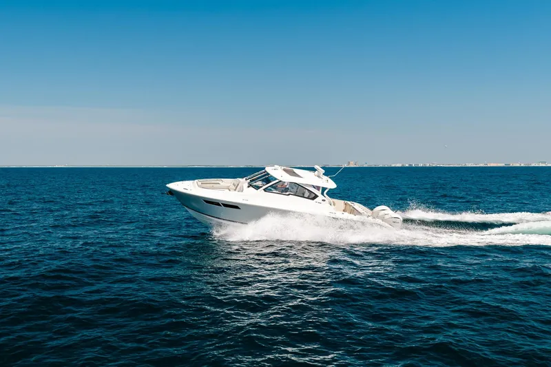 Slide: The Image of 2022 Pursuit DC 365 Dual Console cruising on open blue ocean. - 72