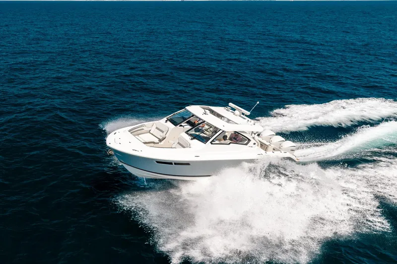 Slide: The Image of 2022 Pursuit DC 365 Dual Console cruising on open ocean waters. - 74