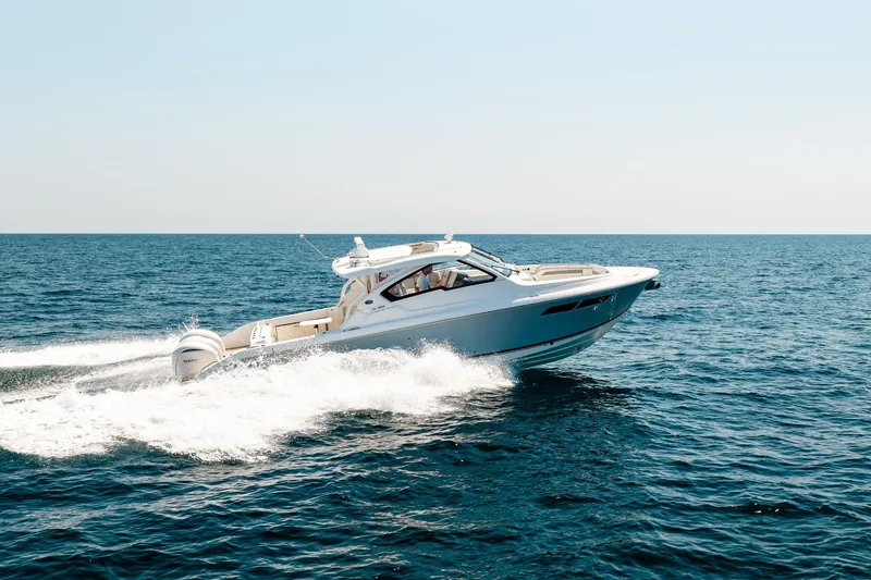 Slide: The Image of 2022 Pursuit DC 365 Dual Console cruising on open sea under clear sky. - 75