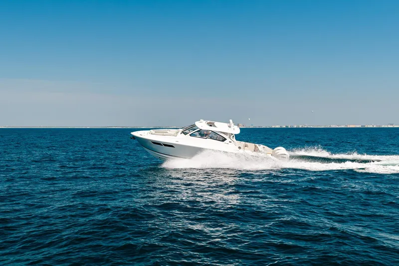 Slide: The Image of 2022 Pursuit DC 365 Dual Console cruising on open blue ocean. - 76