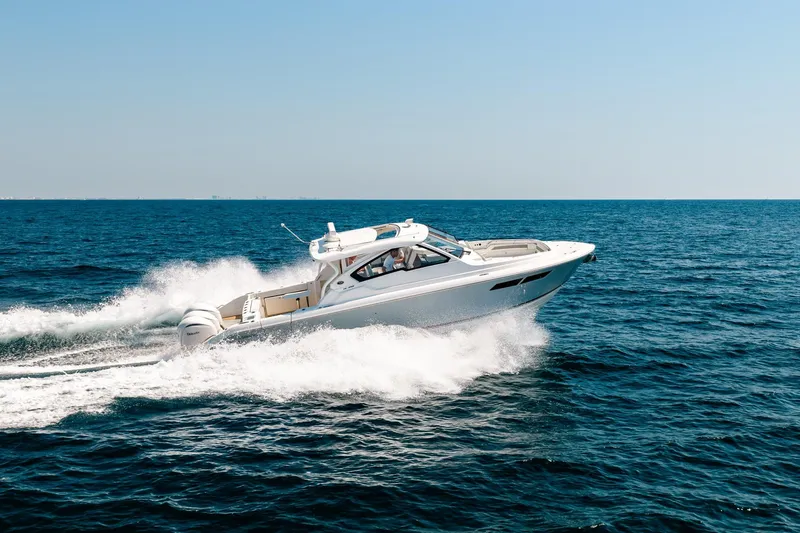 Slide: The Image of 2022 Pursuit DC 365 Dual Console boat cruising on open sea. - 77