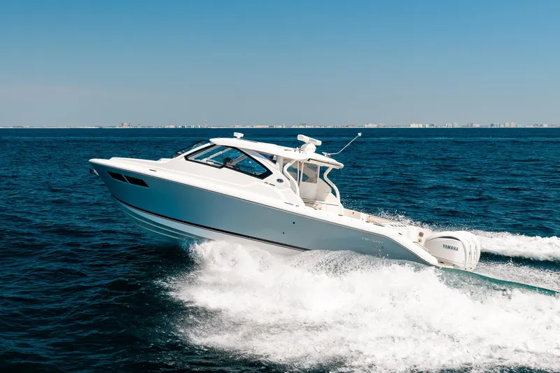 Slide: The Image of 2022 Pursuit DC 365 Dual Console boat cruising on open ocean waters. - 79