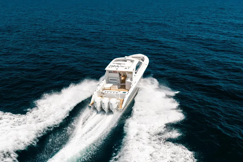 Slide: The Image of 2022 Pursuit DC 365 Dual Console boat cruising on open ocean waters. - 80