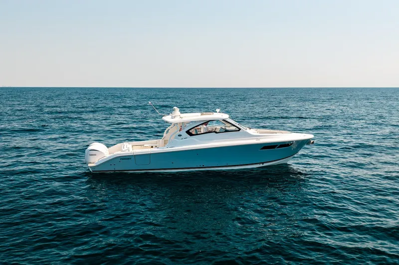 Slide: The Image of 2022 Pursuit DC 365 Dual Console boat cruising on open sea. - 9