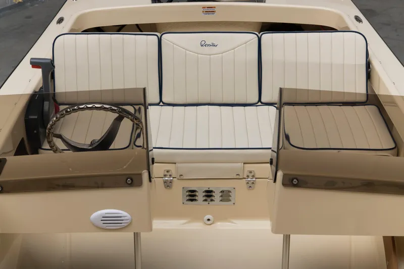 Slide: The Image of Interior of 2026 Rossiter 14 boat with beige seating and steering wheel. - 5