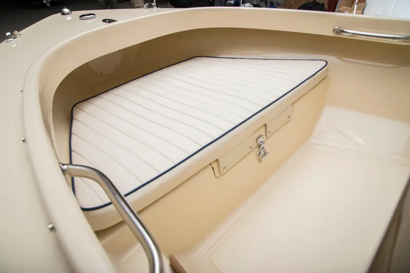 Slide: The Image of 2026 Rossiter 14 boat interior with cushioned seating and storage compartment. - 7