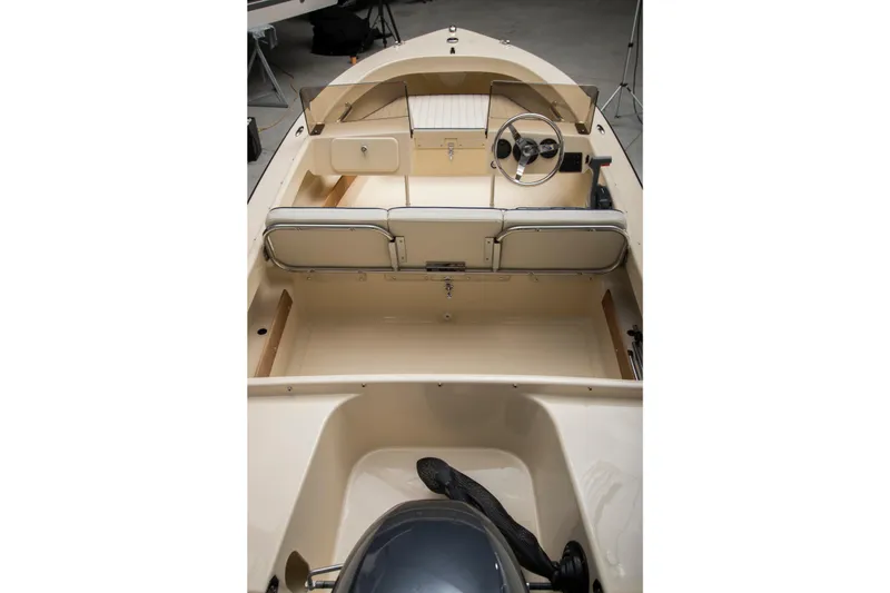 Slide: The Image of 2026 Rossiter 14 boat interior with steering wheel and seating, showcasing sleek design. - 8