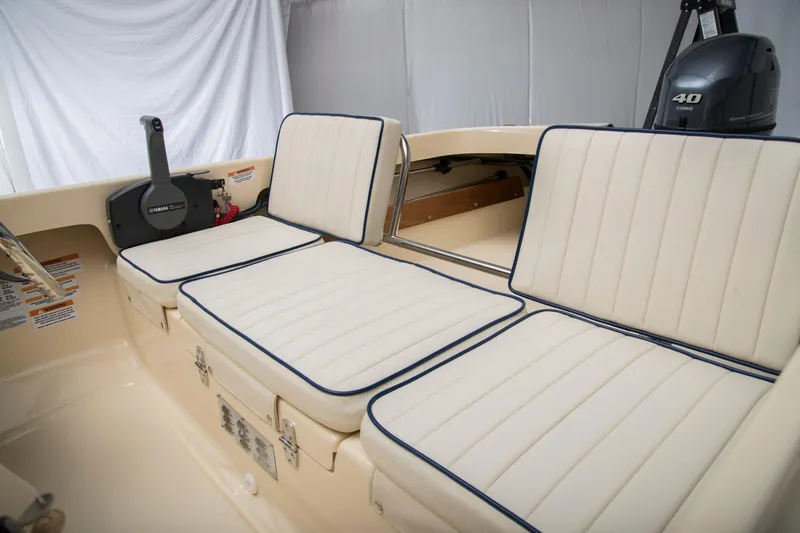 Slide: The Image of 2026 Rossiter 14 boat interior with cushioned seating and Yamaha controls. - 9