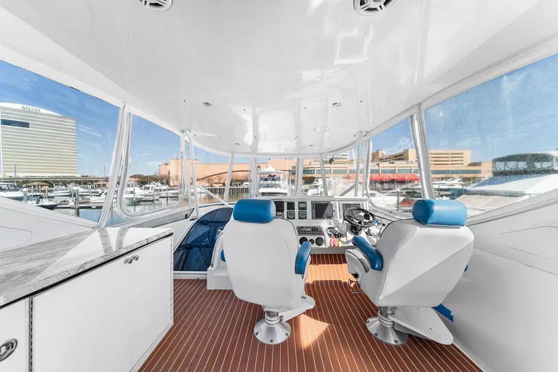 Slide: The Image of Interior view of 2007 Marquis 55 LS yacht cockpit with blue and white seating. - 10