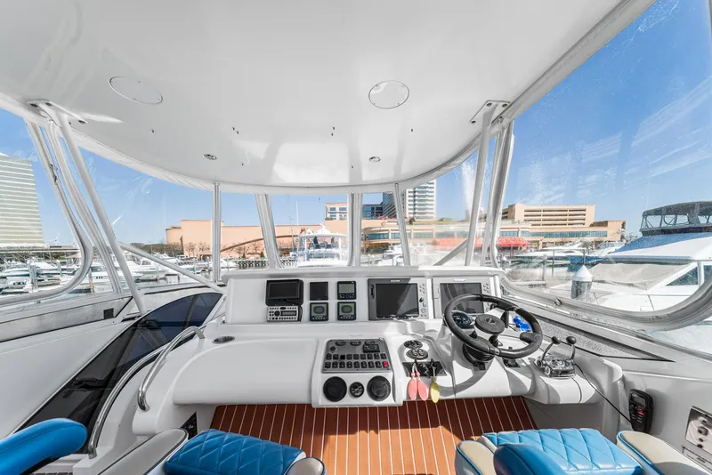 Slide: The Image of Helm of 2007 Marquis 55 LS yacht with modern controls and panoramic marina view. - 13