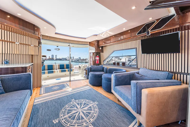 Slide: The Image of Luxurious interior of 2007 Marquis 55 LS yacht with modern seating and city skyline view. - 22