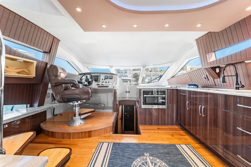 Slide: The Image of Luxurious interior of a 2007 Marquis 55 LS yacht with modern kitchen and captain's chair. - 27