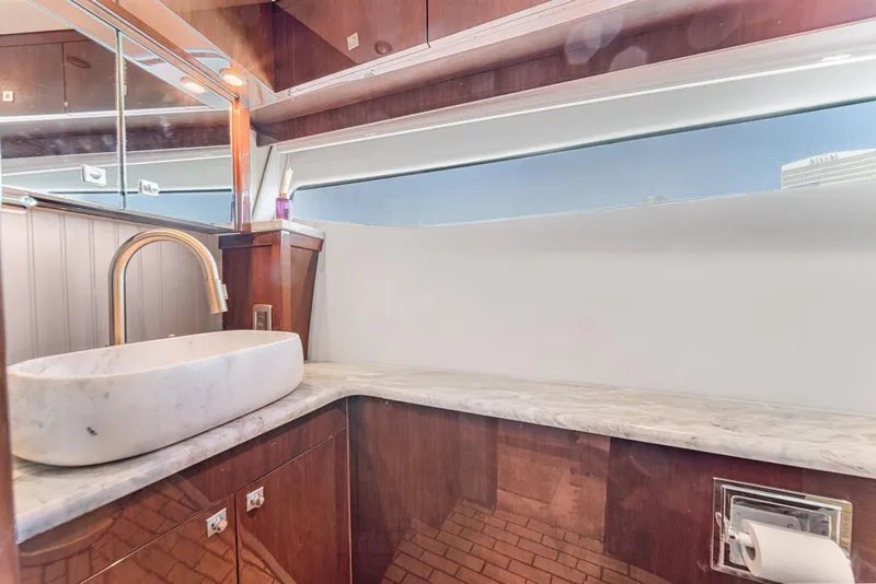 Slide: The Image of Luxurious bathroom interior of 2007 Marquis 55 LS yacht with marble sink and wooden cabinetry. - 34