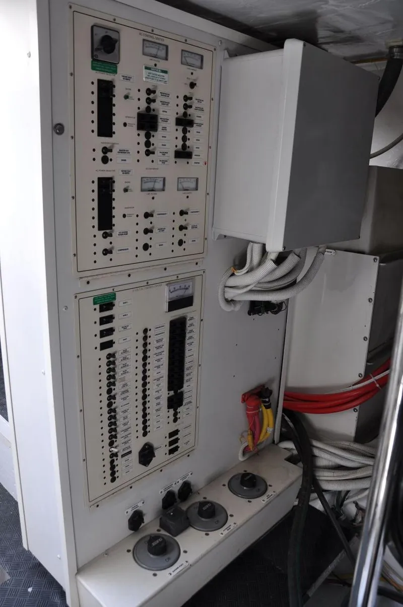 Slide: The Image of Electrical control panel on a 2007 Marquis 55 LS yacht, featuring switches and wiring. - 48