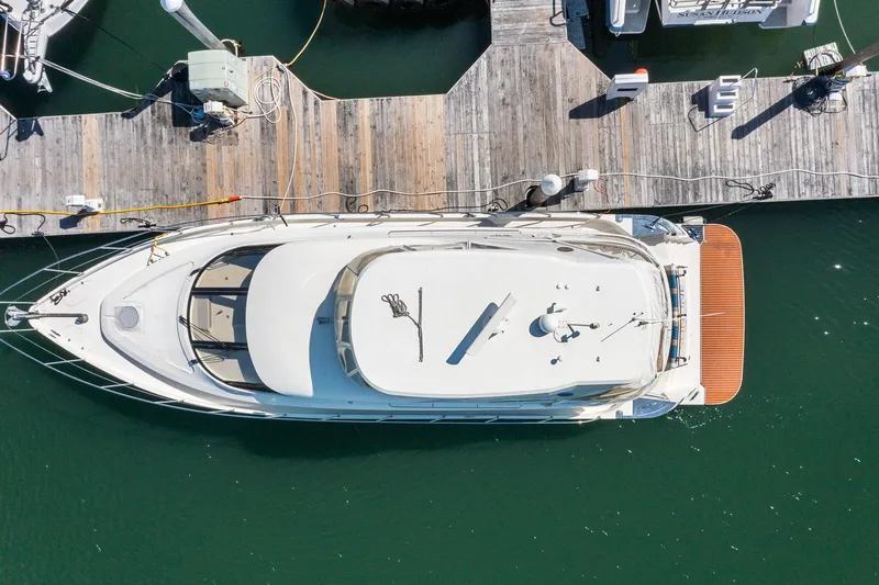 Slide: The Image of Aerial view of a 2007 Marquis 55 LS yacht docked at a wooden pier. - 5
