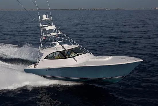 The Image of 2017 Viking 52 Sport Tower yacht on calm water, clear sky background. - 1