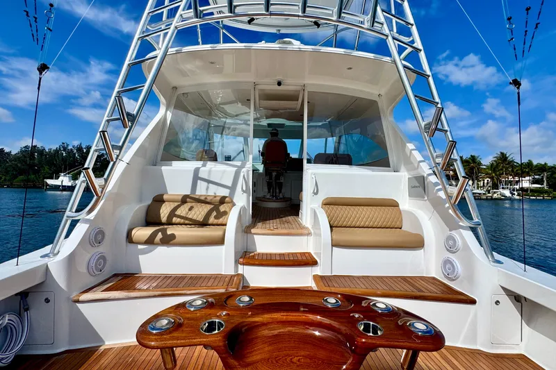 Slide: The Image of 2017 Viking 52 Sport Tower yacht with luxurious seating and fishing setup. - 16