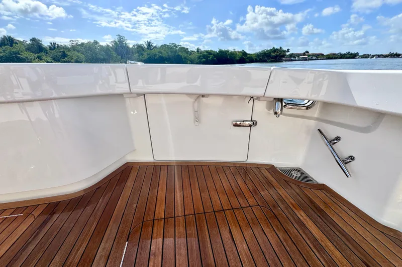 Slide: The Image of 2017 Viking 52 Sport Tower yacht with teak deck and sleek white interior. - 17