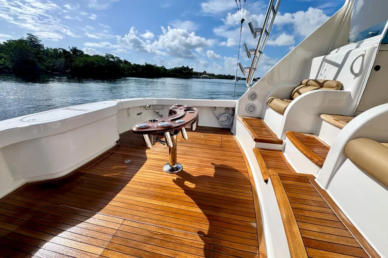 Slide: The Image of Luxurious 2017 Viking 52 Sport Tower yacht deck with wooden flooring and seating. - 18