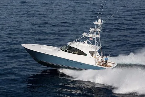 Slide: The Image of 2017 Viking 52 Sport Tower yacht on calm water under blue sky. - 2