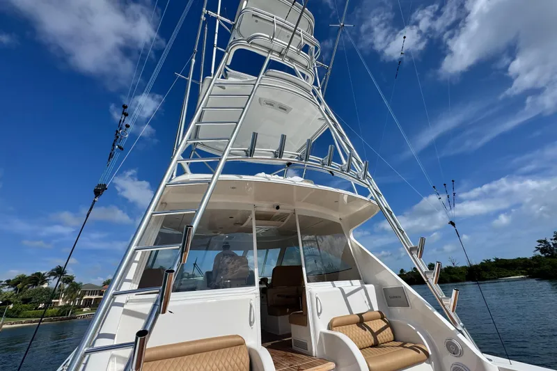 Slide: The Image of 2017 Viking 52 Sport Tower yacht with tower against blue sky. - 20