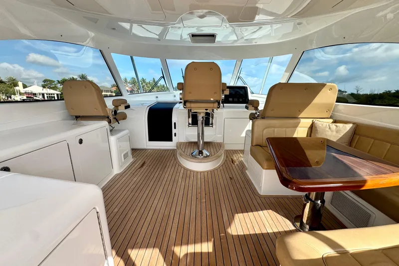 Slide: The Image of Interior of 2017 Viking 52 Sport Tower yacht with luxurious seating and wooden flooring. - 25