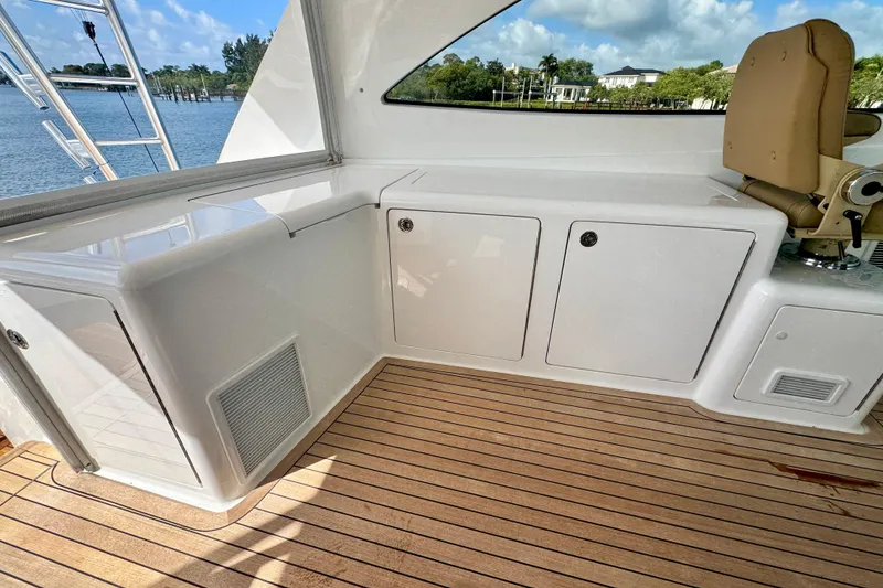 Slide: The Image of 2017 Viking 52 Sport Tower yacht interior with teak flooring and storage cabinets. - 29
