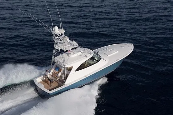 Slide: The Image of 2017 Viking 52 Sport Tower yacht on calm water, clear sky background. - 3