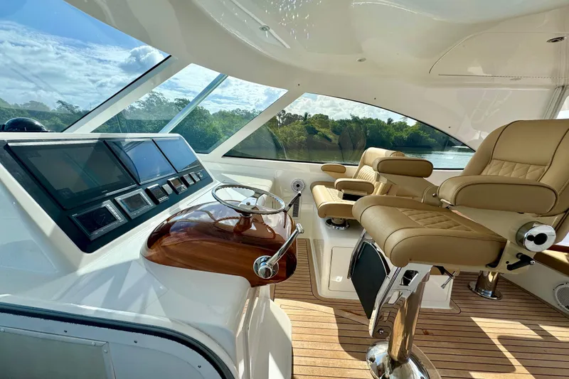 Slide: The Image of Interior of 2017 Viking 52 Sport Tower yacht with luxurious seating and modern controls. - 32