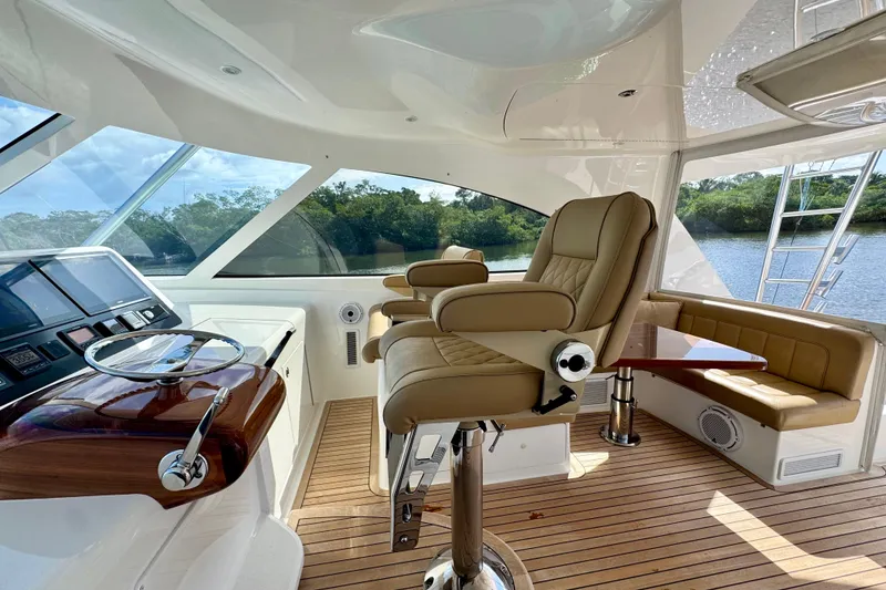 Slide: The Image of Luxurious interior of 2017 Viking 52 Sport Tower yacht with leather seating and modern helm. - 33