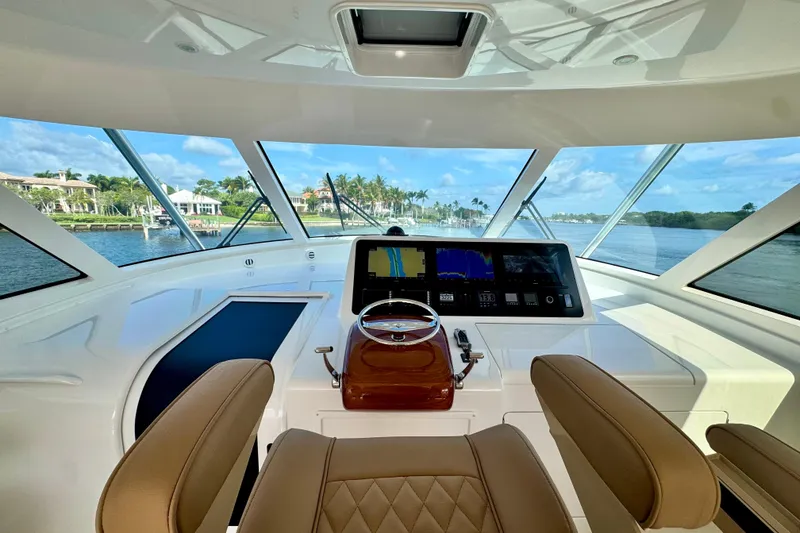 Slide: The Image of Interior view of 2017 Viking 52 Sport Tower yacht helm with navigation screens. - 34