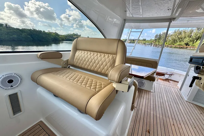 Slide: The Image of Luxurious interior of 2017 Viking 52 Sport Tower yacht with plush seating and scenic water view. - 35