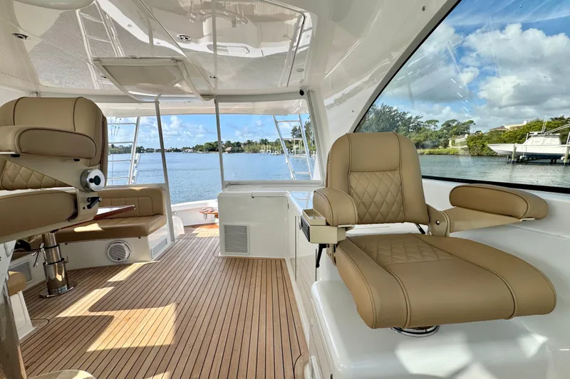 Slide: The Image of Luxurious interior of 2017 Viking 52 Sport Tower yacht with tan leather seating. - 37