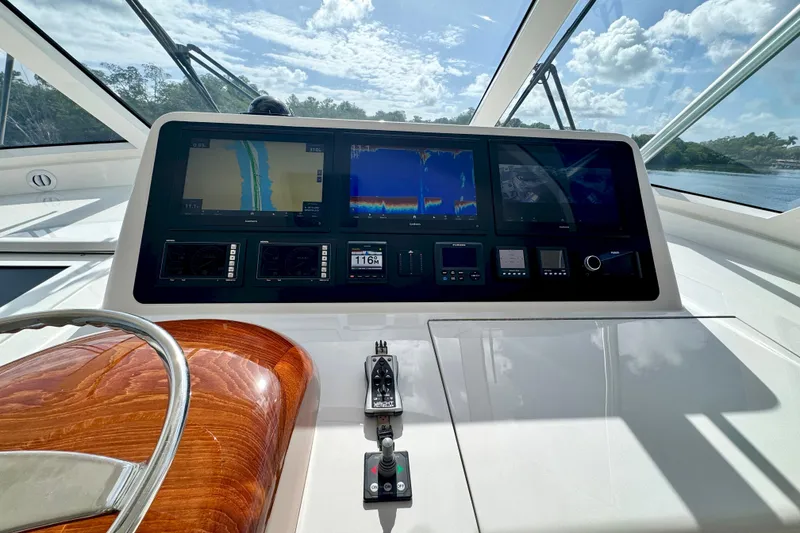Slide: The Image of Control panel of 2017 Viking 52 Sport Tower yacht with navigation screens and steering wheel. - 38
