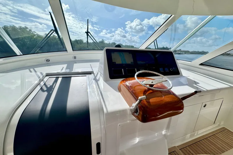 Slide: The Image of Helm of 2017 Viking 52 Sport Tower yacht with modern controls and panoramic view. - 39