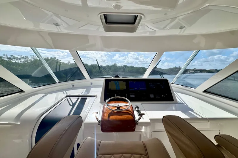 Slide: The Image of Interior view of 2017 Viking 52 Sport Tower yacht helm with panoramic windows. - 40