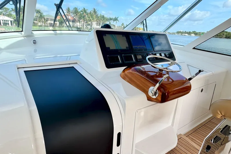 Slide: The Image of Helm of 2017 Viking 52 Sport Tower yacht with modern controls and navigation screens. - 42