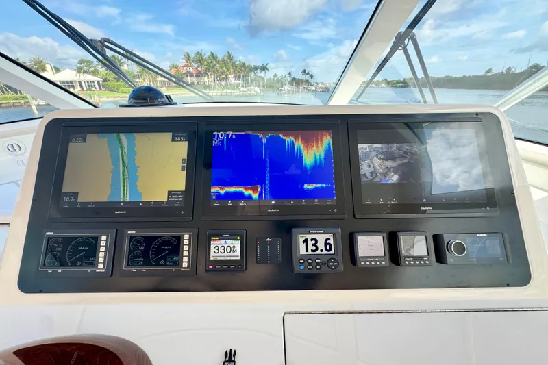 Slide: The Image of Control panel of a 2017 Viking 52 Sport Tower with navigation displays. - 44