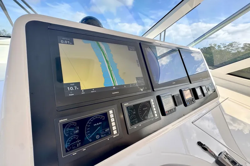 Slide: The Image of 2017 Viking 52 Sport Tower helm with advanced navigation displays and controls. - 47