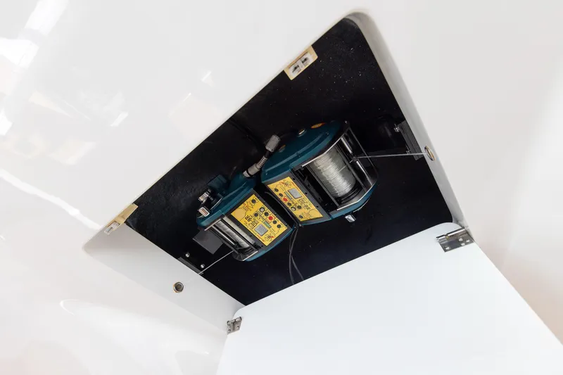 Slide: The Image of 2017 Viking 52 Sport Tower fishing reel compartment with mounted equipment. - 48