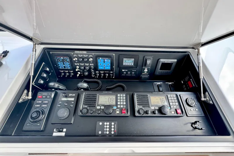 Slide: The Image of Control panel of 2017 Viking 52 Sport Tower with communication and navigation equipment. - 54