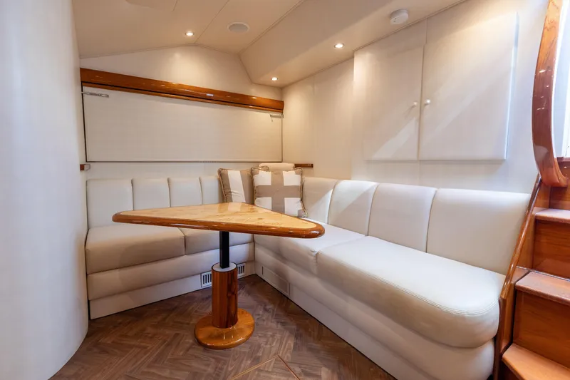 Slide: The Image of Luxurious interior of 2017 Viking 52 Sport Tower yacht with elegant seating and wooden table. - 58