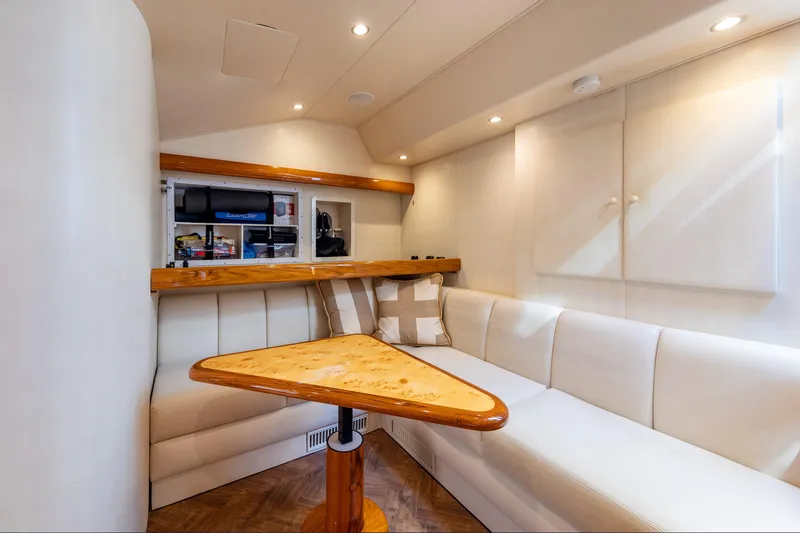Slide: The Image of Luxurious interior of 2017 Viking 52 Sport Tower yacht with elegant seating and wooden table. - 59