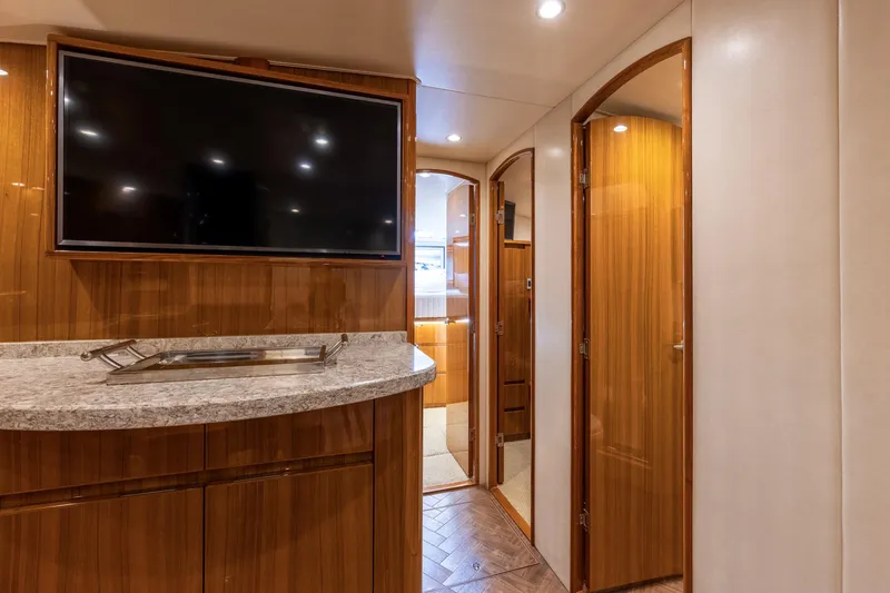 Slide: The Image of Luxurious interior of 2017 Viking 52 Sport Tower yacht with wood finishes and flat-screen TV. - 60