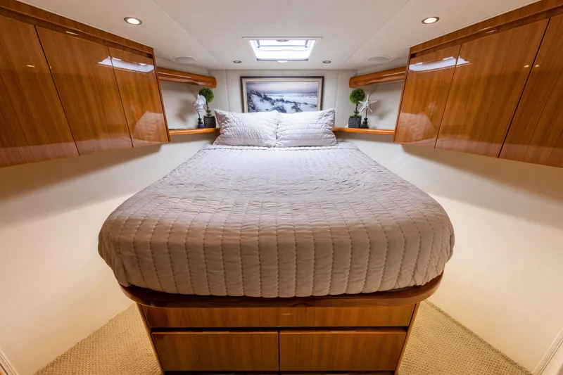 Slide: The Image of Luxurious cabin interior of 2017 Viking 52 Sport Tower yacht with elegant wood finishes. - 63
