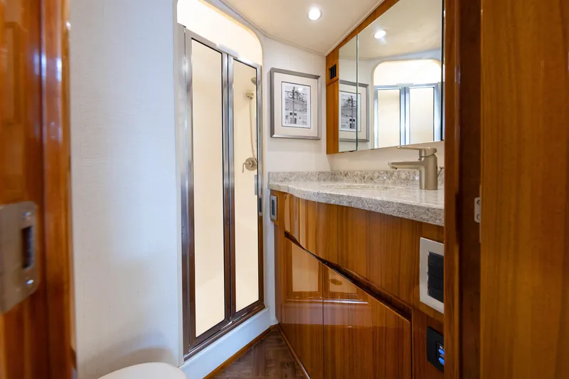 Slide: The Image of Luxurious bathroom interior of 2017 Viking 52 Sport Tower yacht with wood cabinetry and modern fixtures. - 66