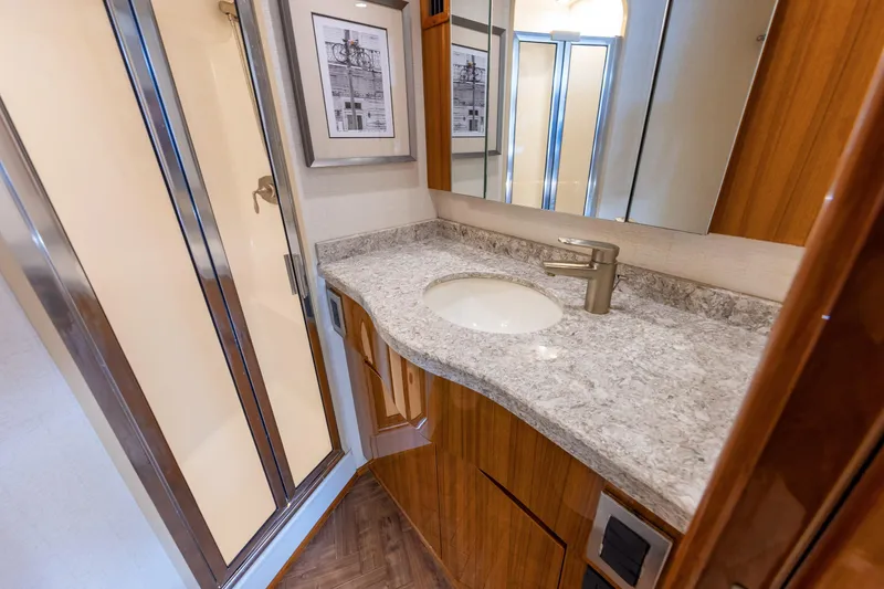 Slide: The Image of Luxurious bathroom in 2017 Viking 52 Sport Tower yacht with granite countertop and shower. - 67